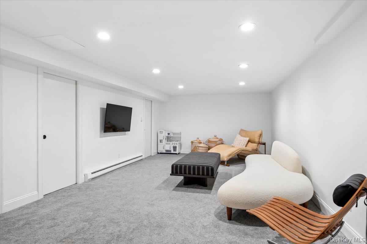 73 Atherstone Road Scarsdale, NY 10583 - Photo 25 of 34 a living room with furniture and a flat screen tv