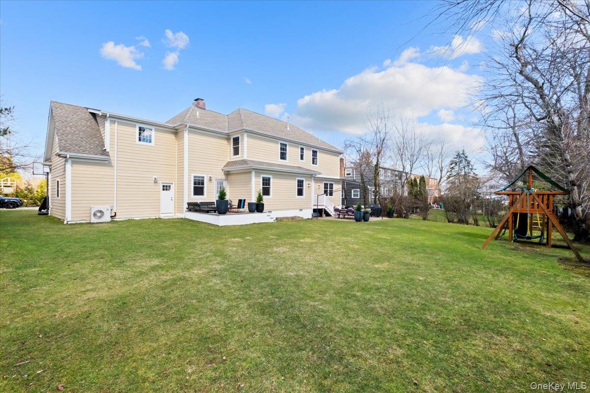 73 Atherstone Road Scarsdale, NY 10583 - Photo 28 of 34 a view of a white house with a big yard and large trees