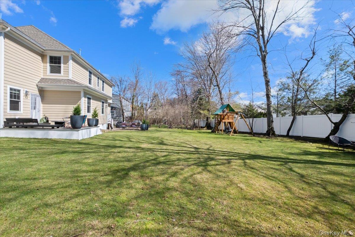 73 Atherstone Road Scarsdale, NY 10583 - Photo 29 of 34 a view of a house with a yard