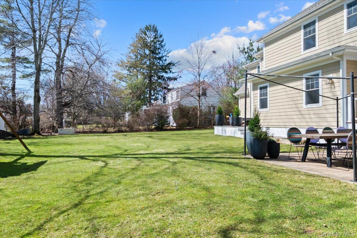 73 Atherstone Road Scarsdale, NY 10583 - Photo 30 of 34 a view of a house with a yard and a tree