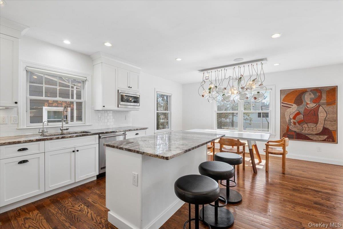 73 Atherstone Road Scarsdale, NY 10583 - Photo 4 of 34 a open kitchen with stainless steel appliances granite countertop a stove a sink and a refrigerator