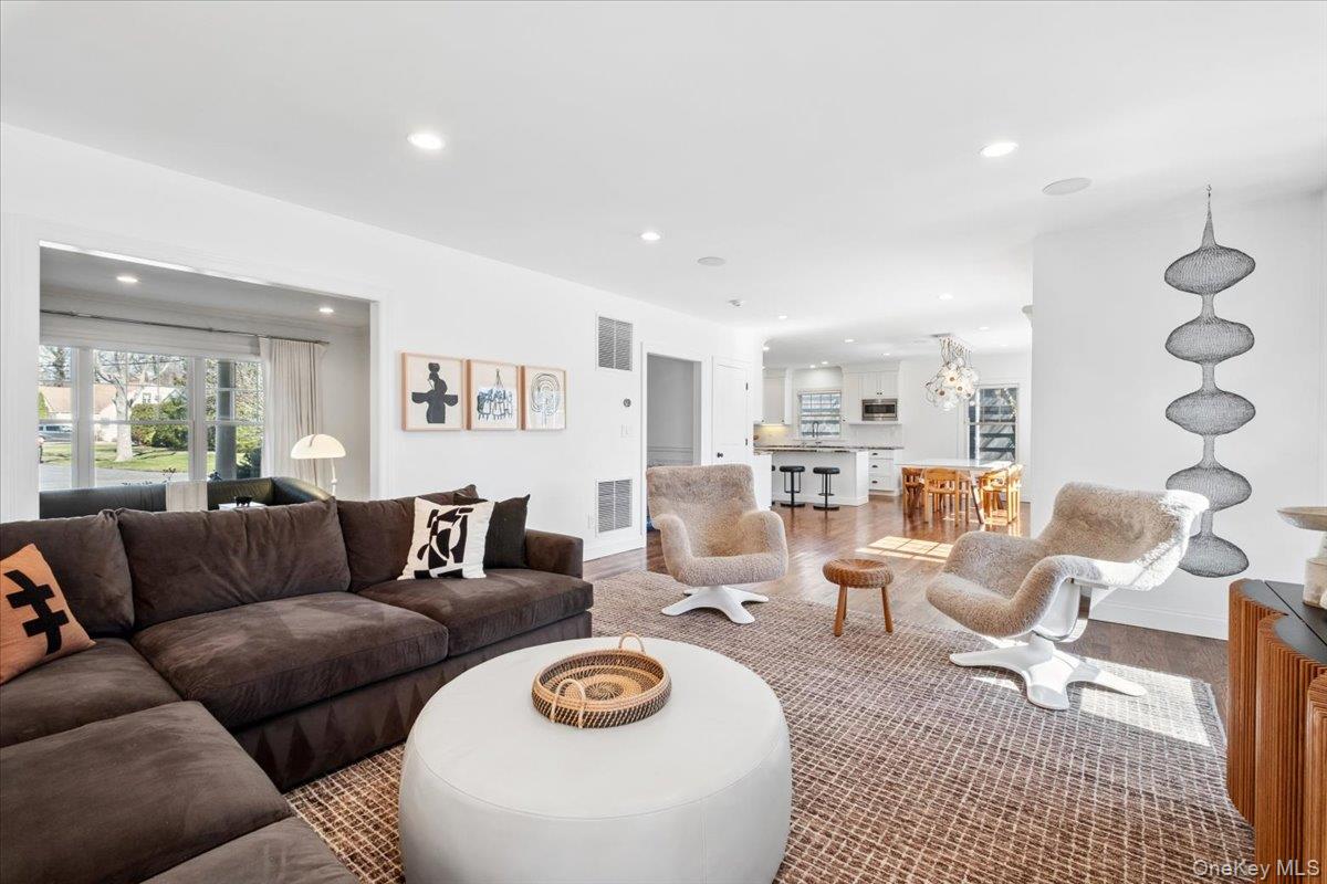 73 Atherstone Road Scarsdale, NY 10583 - Photo 10 of 34 a living room with furniture a rug kitchen view and a large window