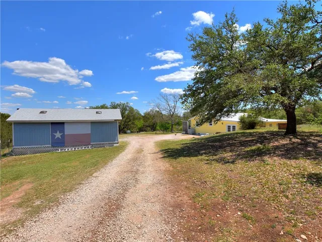 a view of a porch with furniture and garden