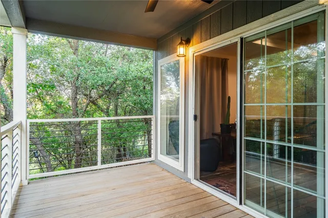 a view of a glass door with wooden floor and next to a window
