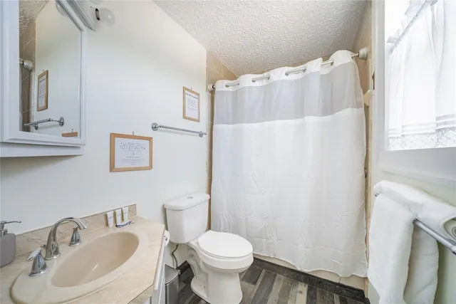 a white toilet sitting next to a bathroom sink