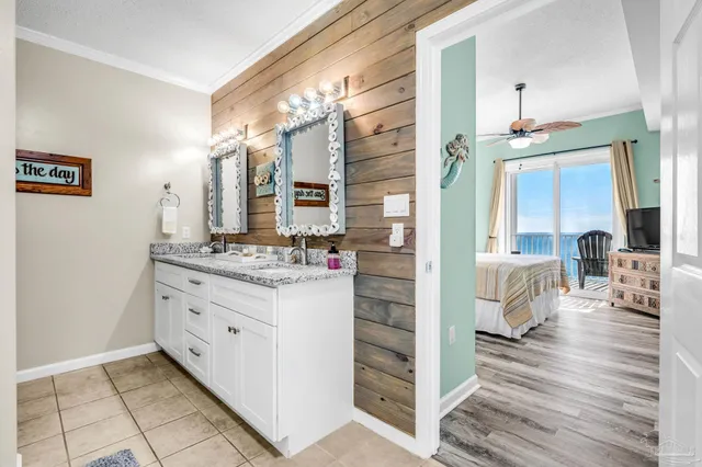 a bathroom with a double vanity sink mirror and shower