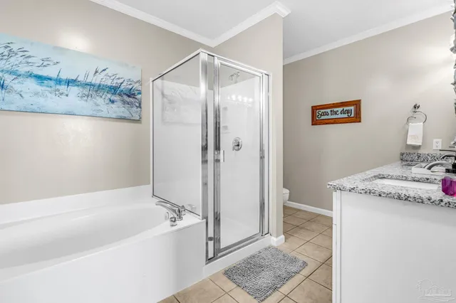 a bathroom with a granite countertop bathtub and shower