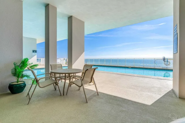 a dining room with furniture and a potted plant