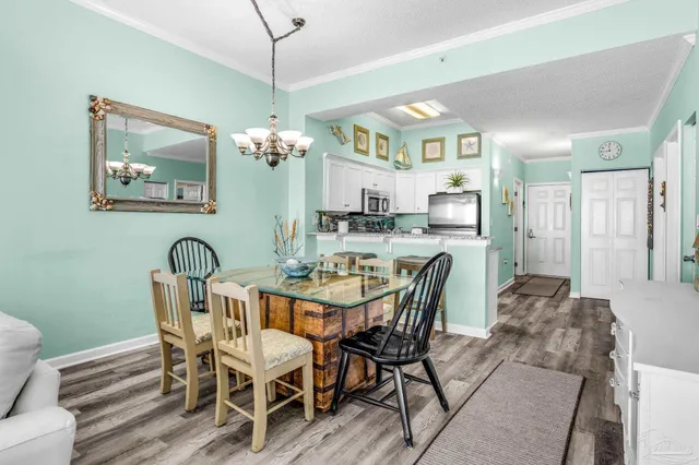 a view of a dining room with furniture and chandelier