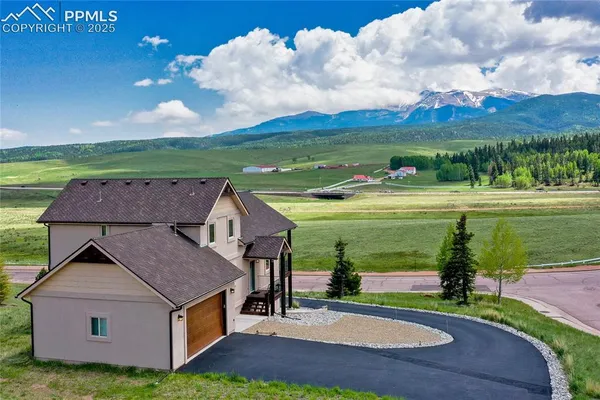 an aerial view of a house with a yard