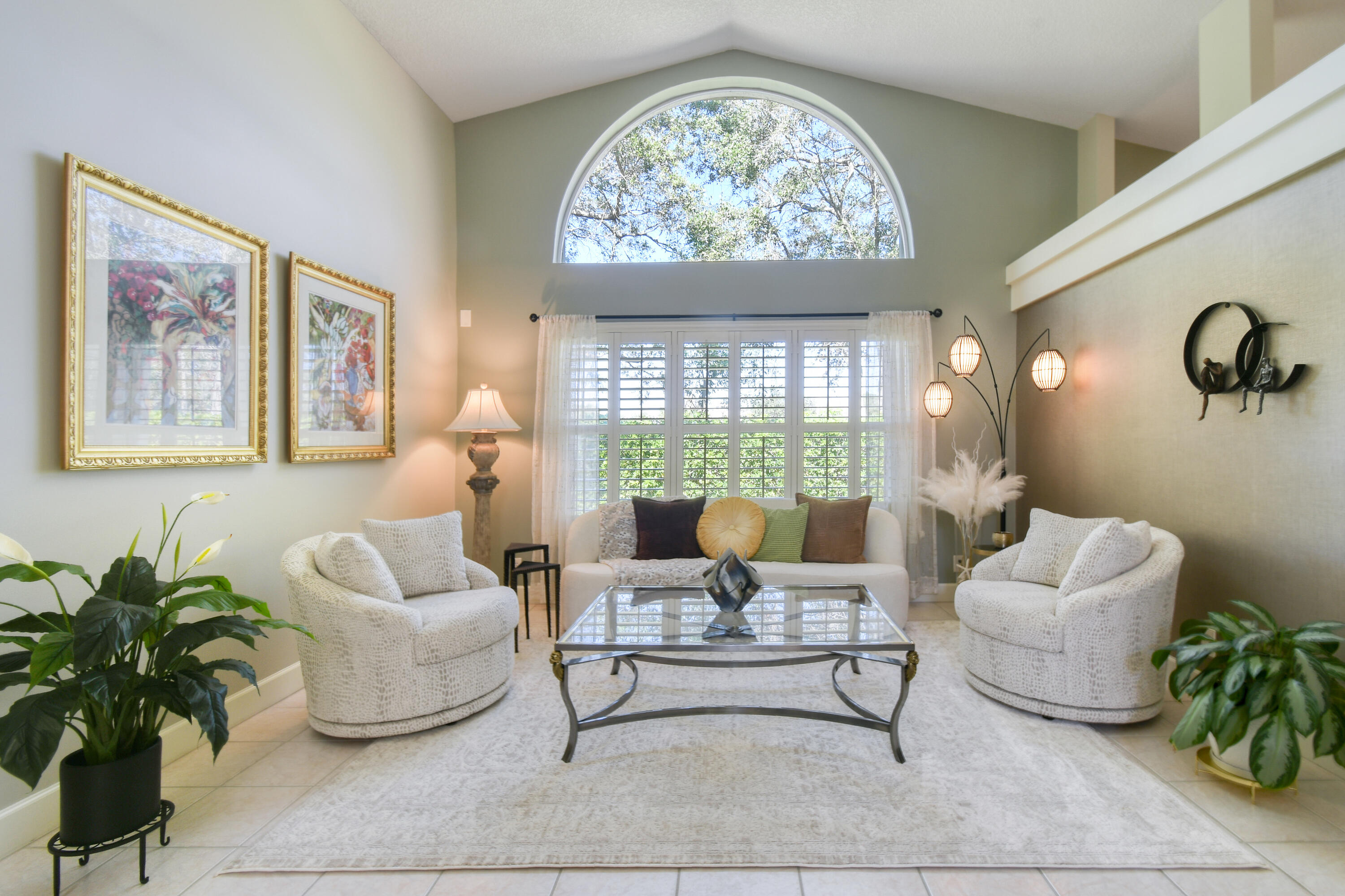 163 Spoonbill Court Jupiter, FL 33458 - Photo 12 of 67 a living room with furniture a lamp and a potted plant