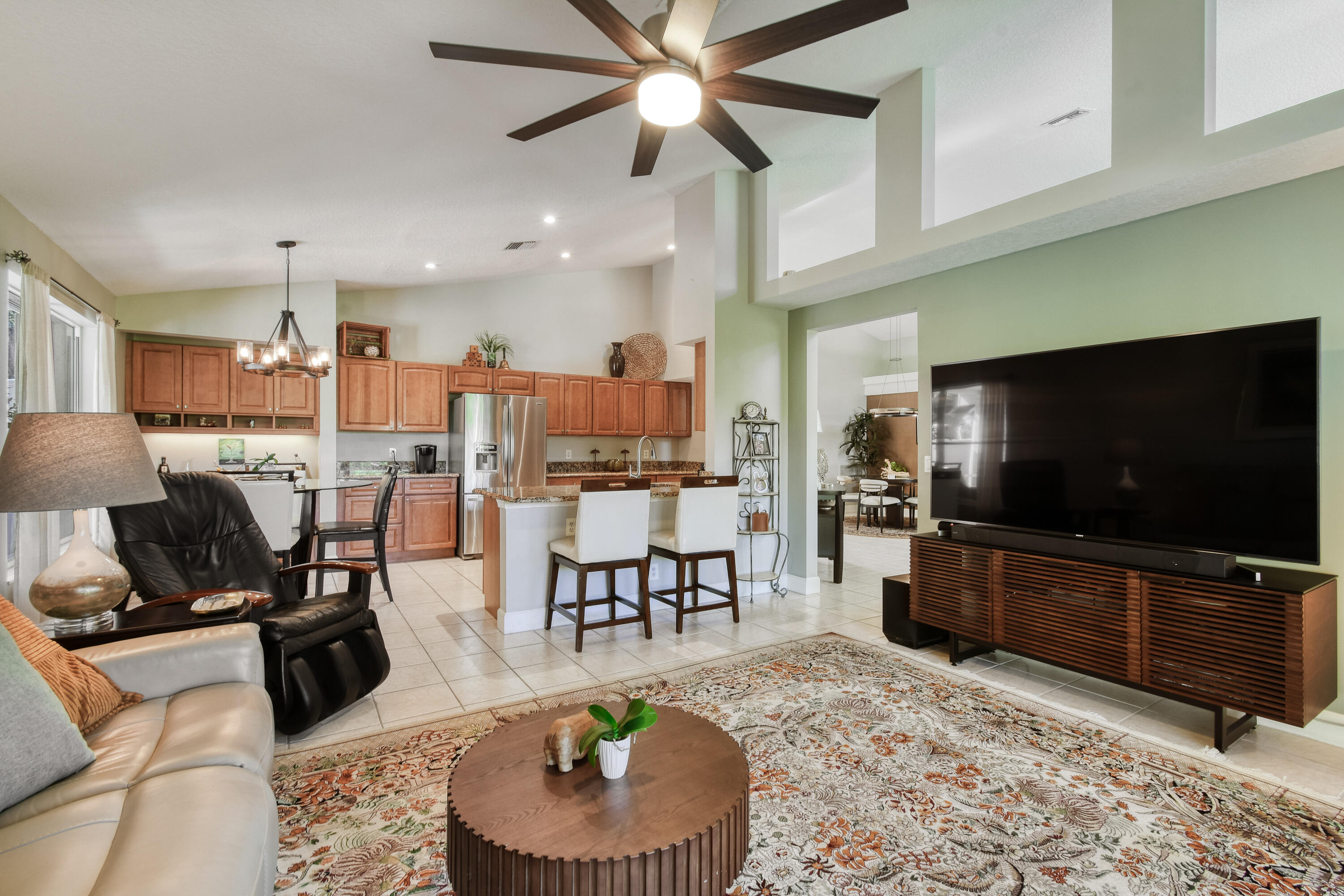 163 Spoonbill Court Jupiter, FL 33458 - Photo 25 of 67 a living room with furniture and a flat screen tv