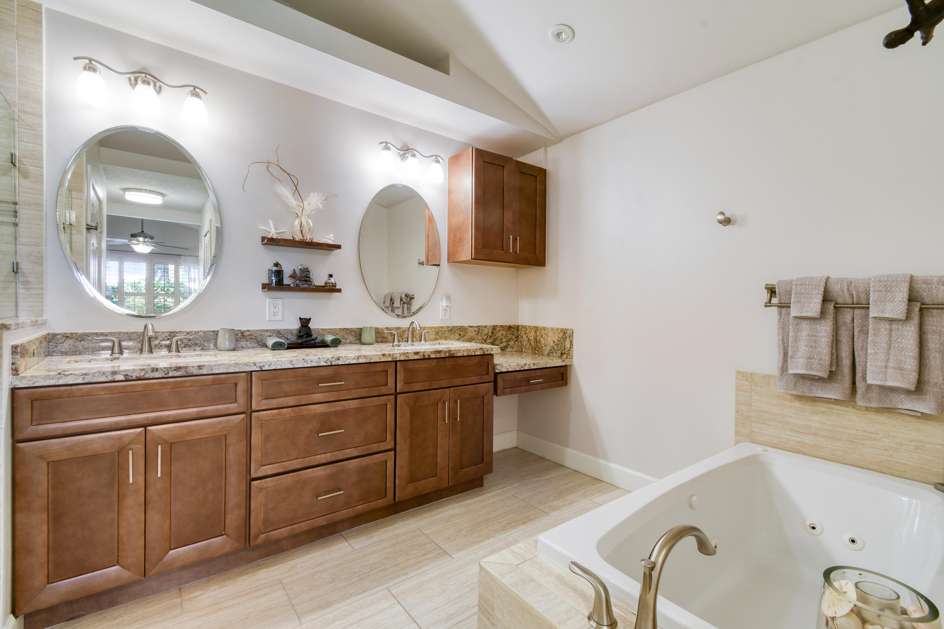 163 Spoonbill Court Jupiter, FL 33458 - Photo 34 of 67 a spacious bathroom with a granite countertop sink a mirror and bathtub