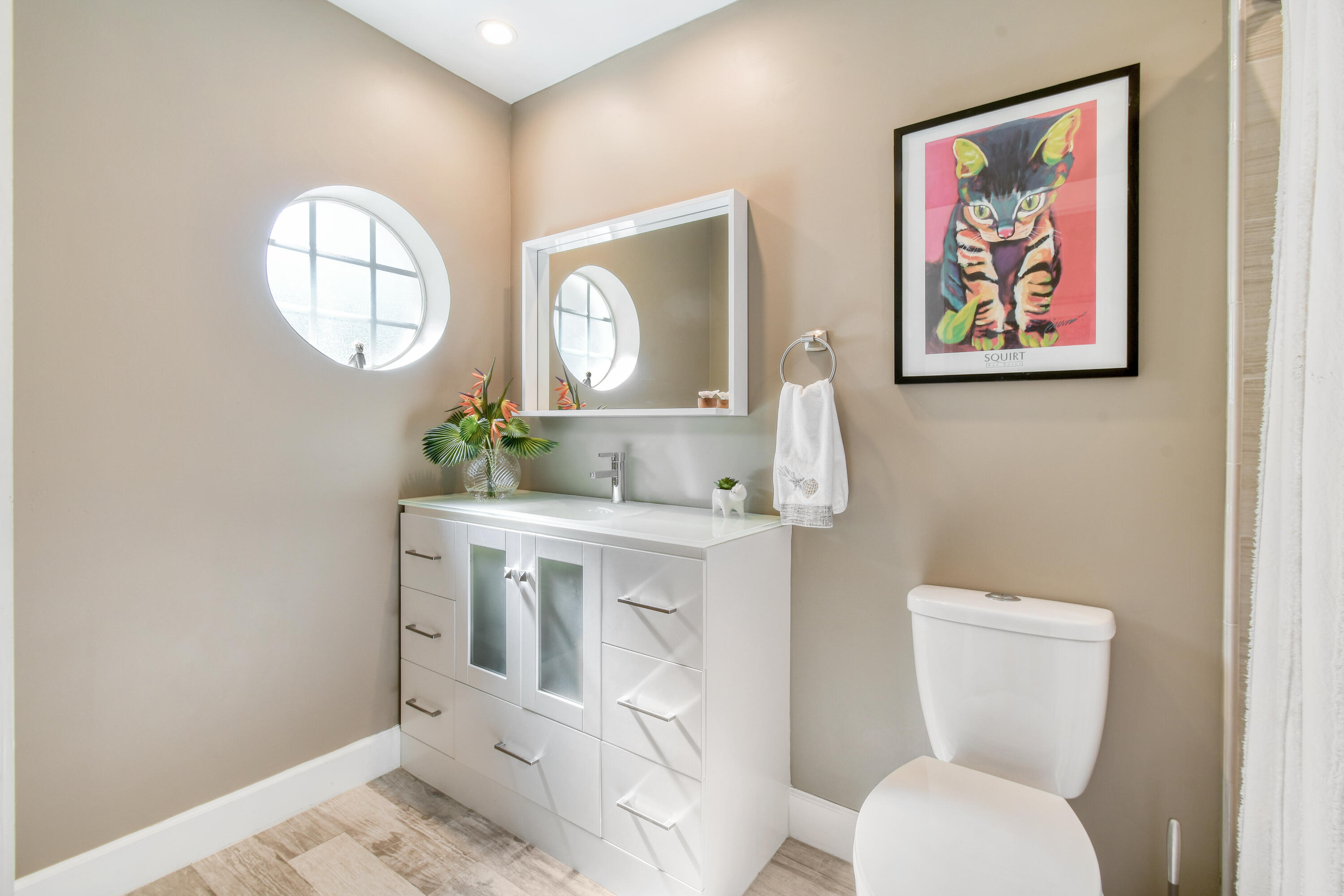 163 Spoonbill Court Jupiter, FL 33458 - Photo 38 of 67 a bathroom with a toilet a sink and a mirror