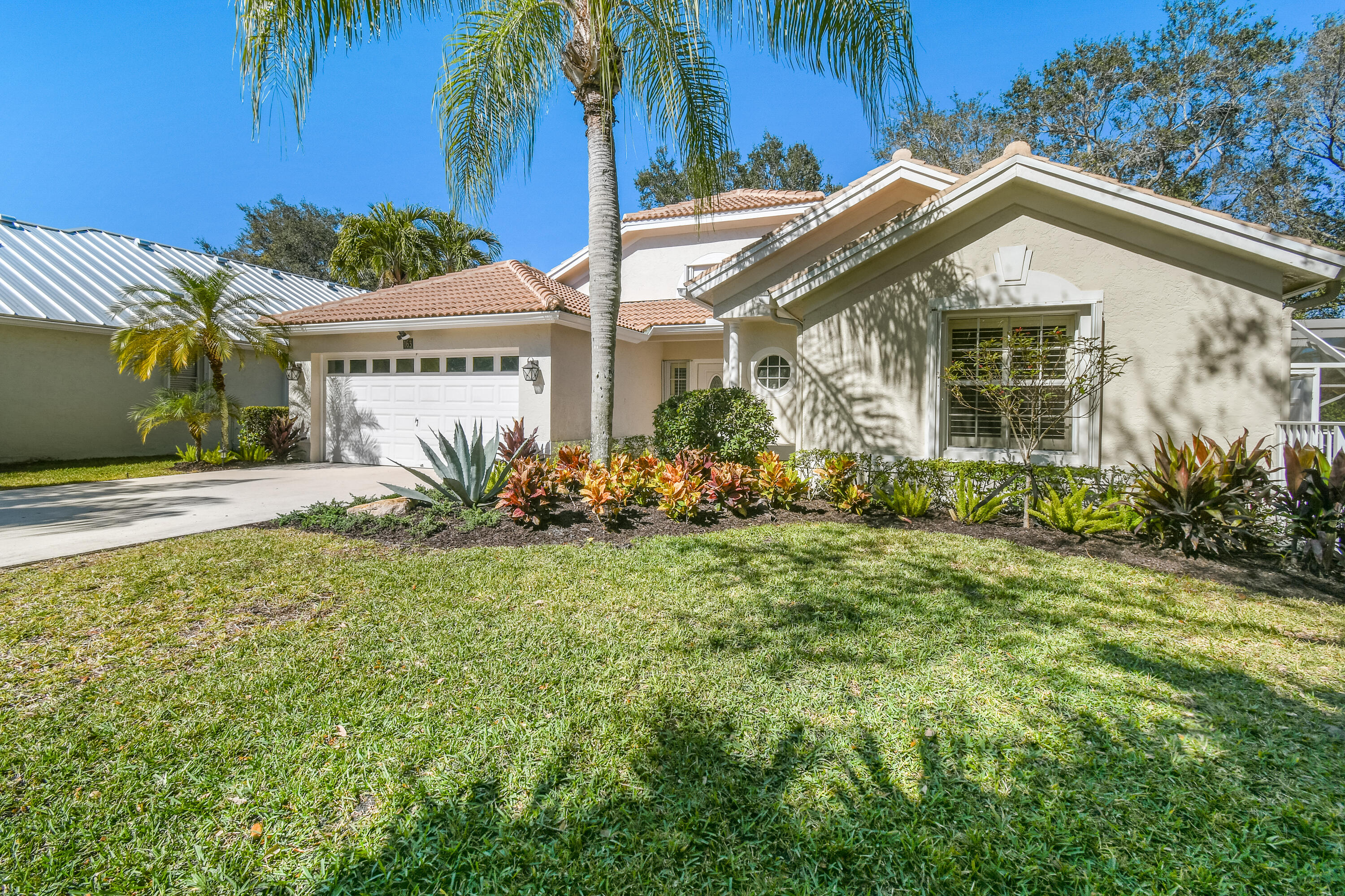 163 Spoonbill Court Jupiter, FL 33458 - Photo 4 of 67 a front view of a house with a yard
