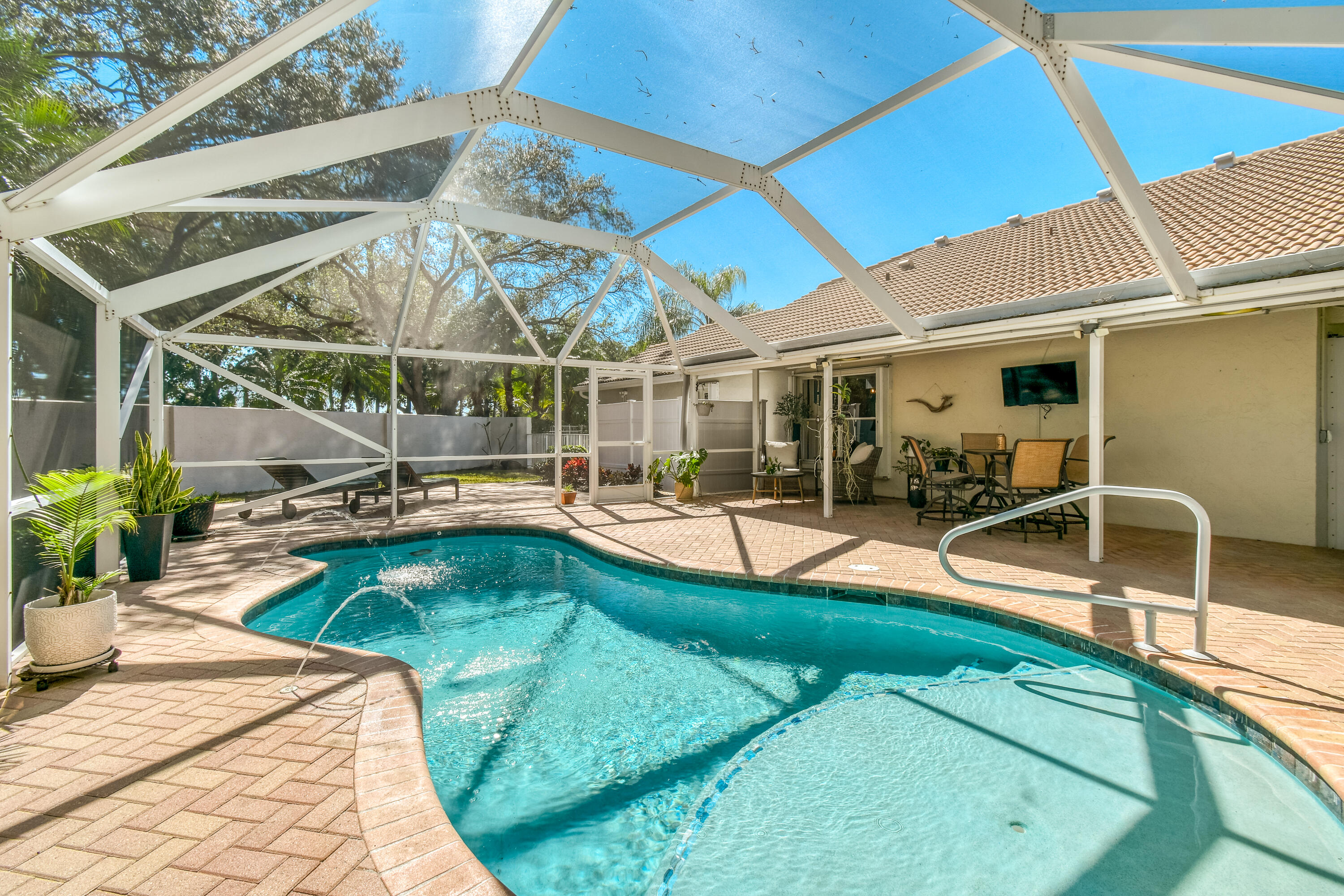 163 Spoonbill Court Jupiter, FL 33458 - Photo 46 of 67 a view of a patio with swimming pool