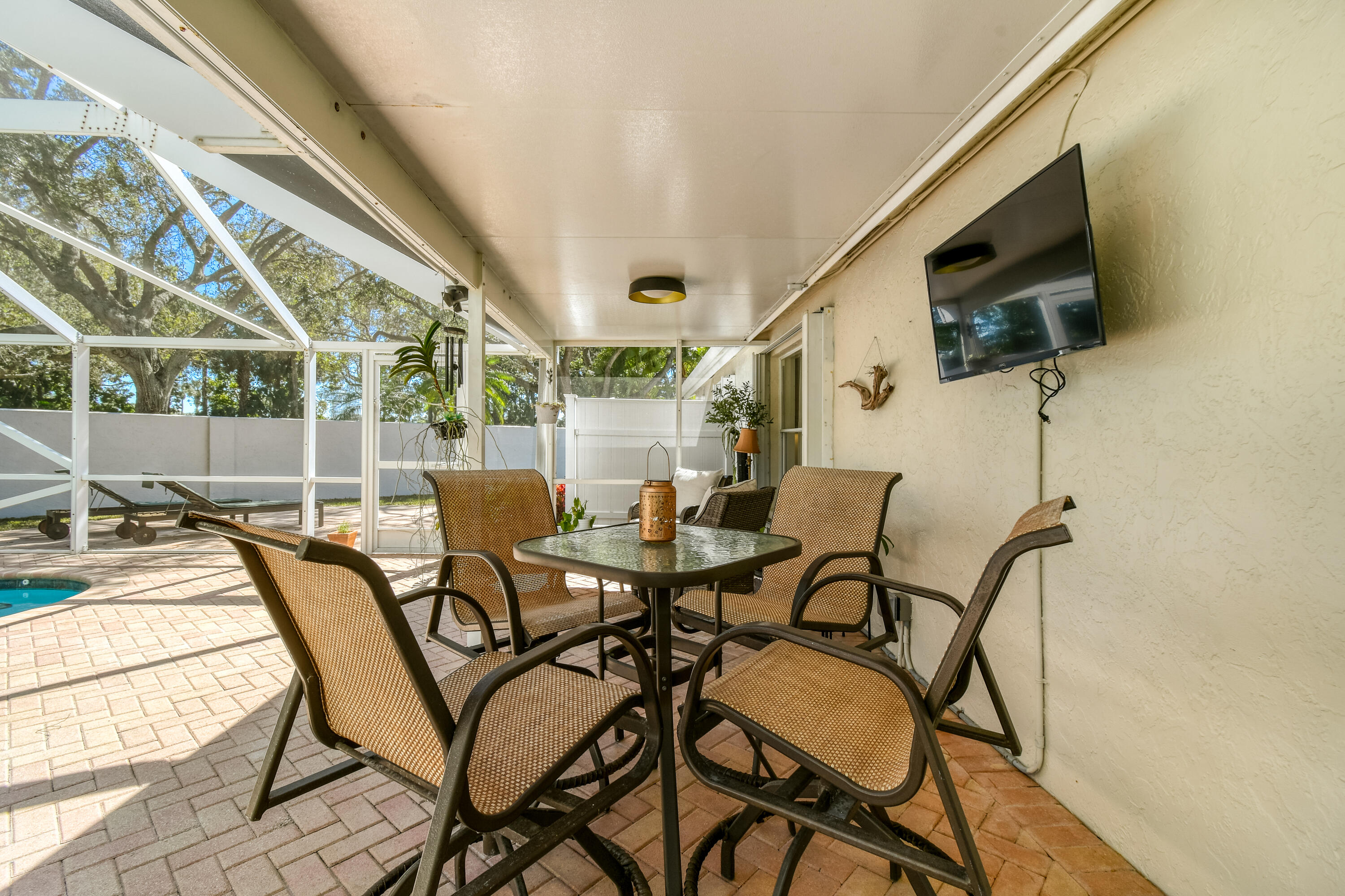 163 Spoonbill Court Jupiter, FL 33458 - Photo 49 of 67 a view of a dining room with furniture and a flat screen tv