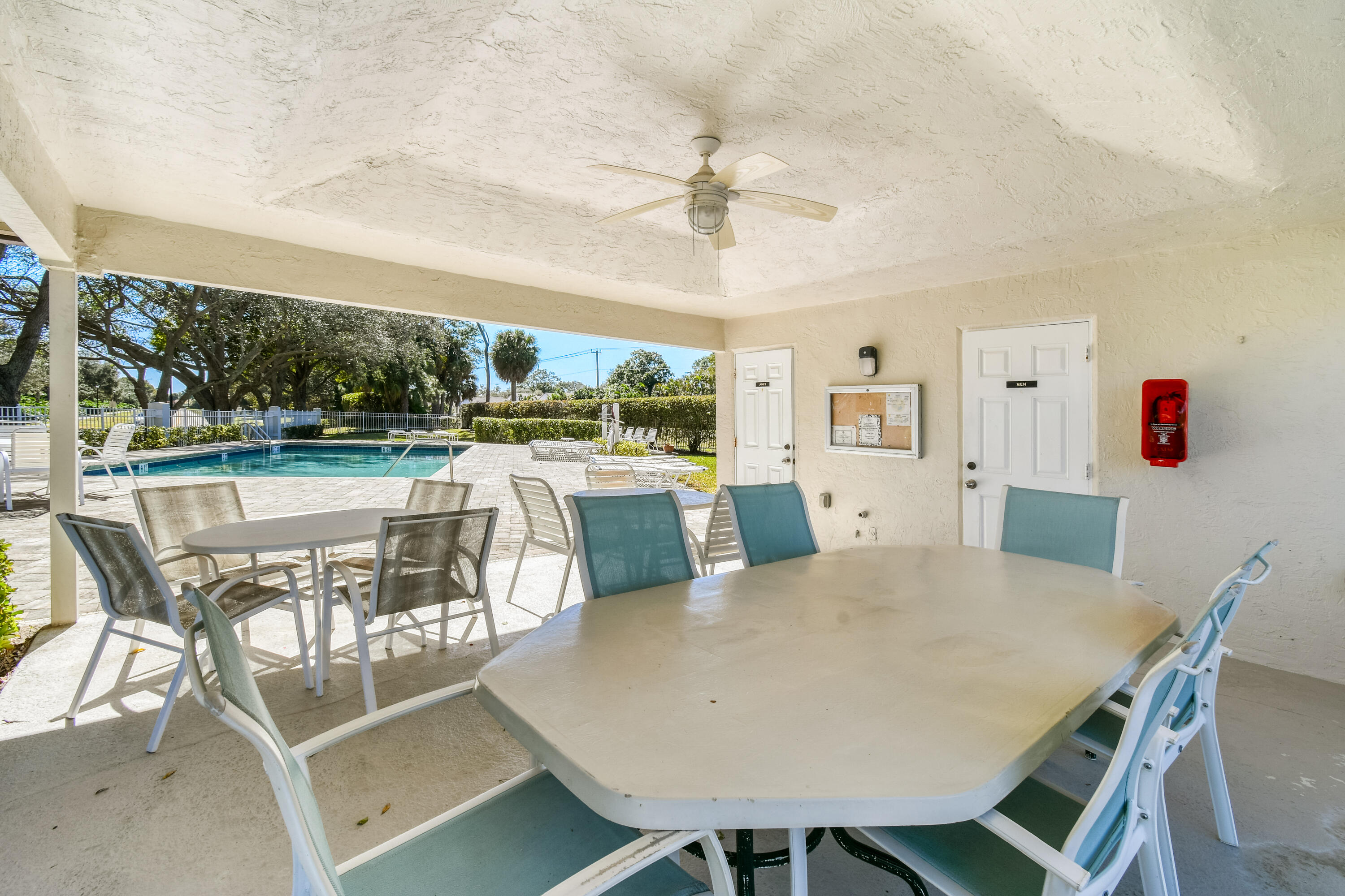 163 Spoonbill Court Jupiter, FL 33458 - Photo 59 of 67 a view of a dining room with furniture large window and wooden floor