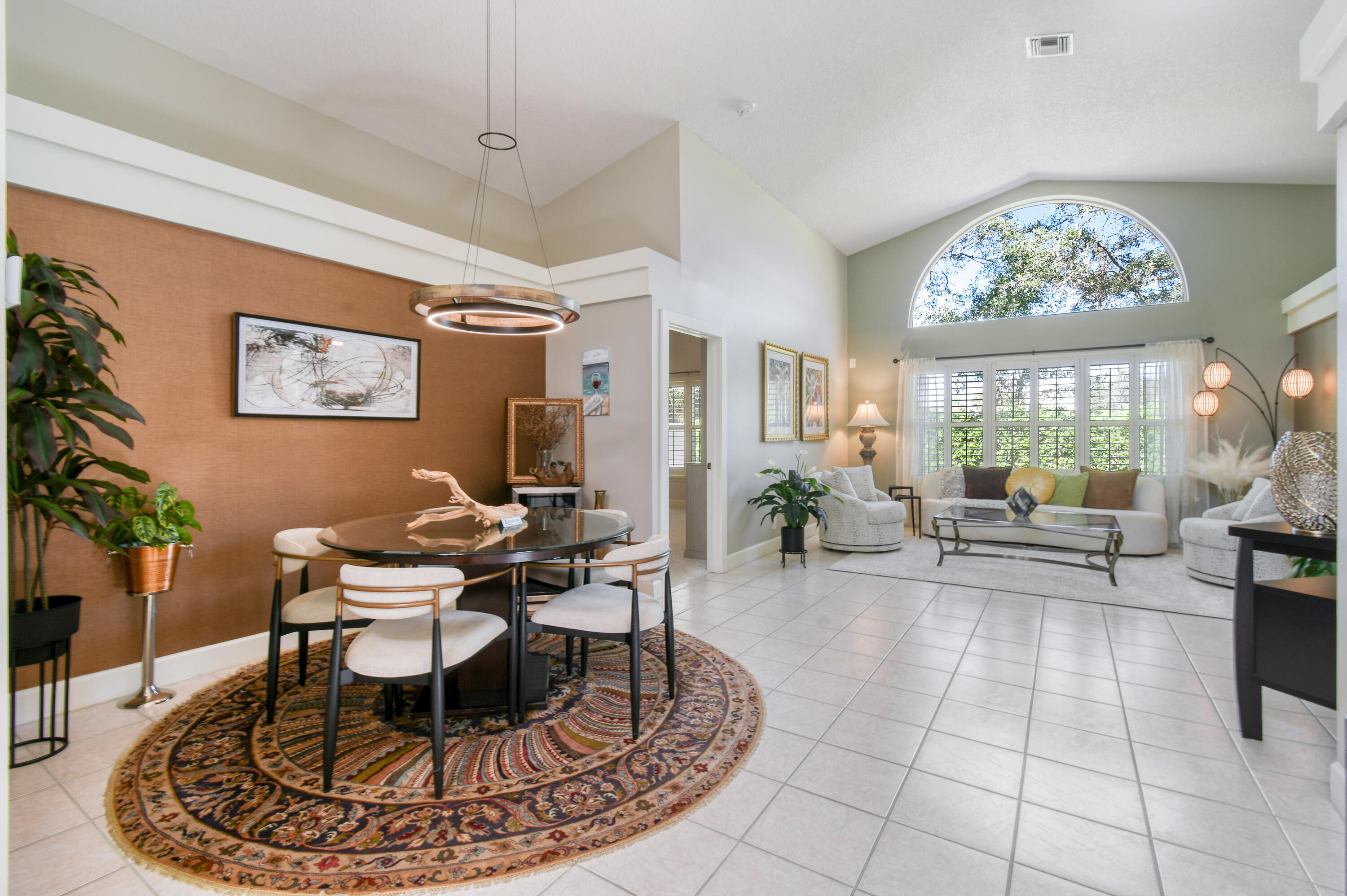 163 Spoonbill Court Jupiter, FL 33458 - Photo 9 of 67 a living room with furniture a large window and dining table