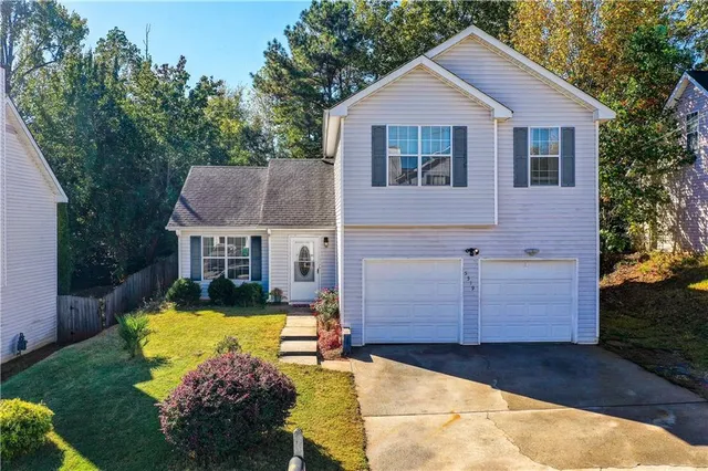 a view of house with yard and swimming pool
