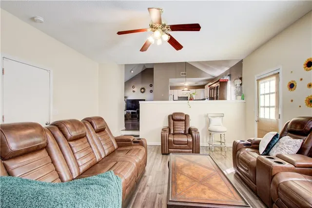 a living room with furniture ceiling fan