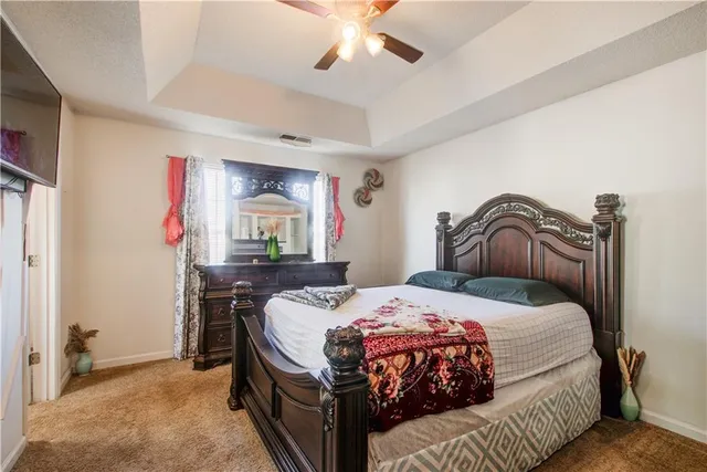 a bedroom with a bed and a mirror