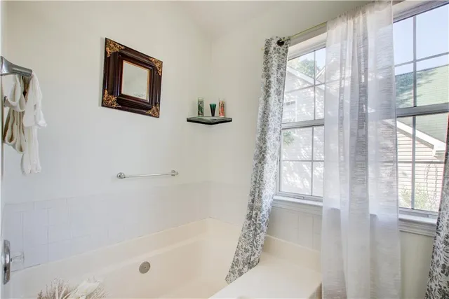 a white bath tub sitting next to a window