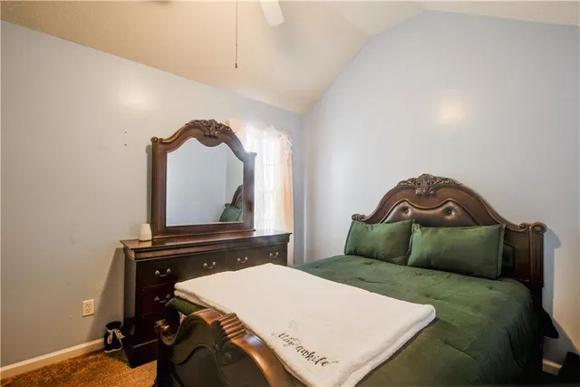 a bedroom with a bed and a mirror