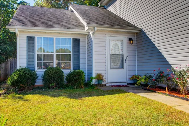 a front view of house and yard with swimming pool and porch