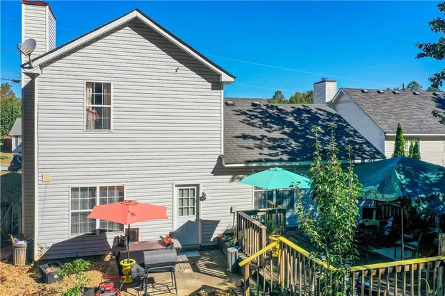 a view of a patio with table and chairs under an umbrella