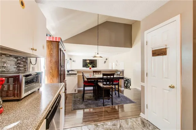 a dining room with furniture and wooden floor