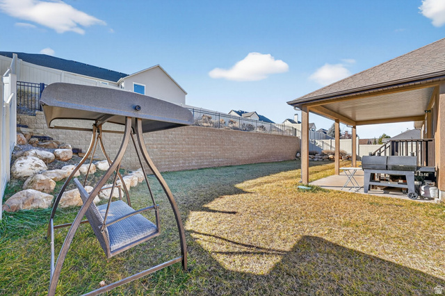 141 Wolverine Creek Elk Ridge, UT 84651 - Photo 36 of 47 Fenced backyard with a patio