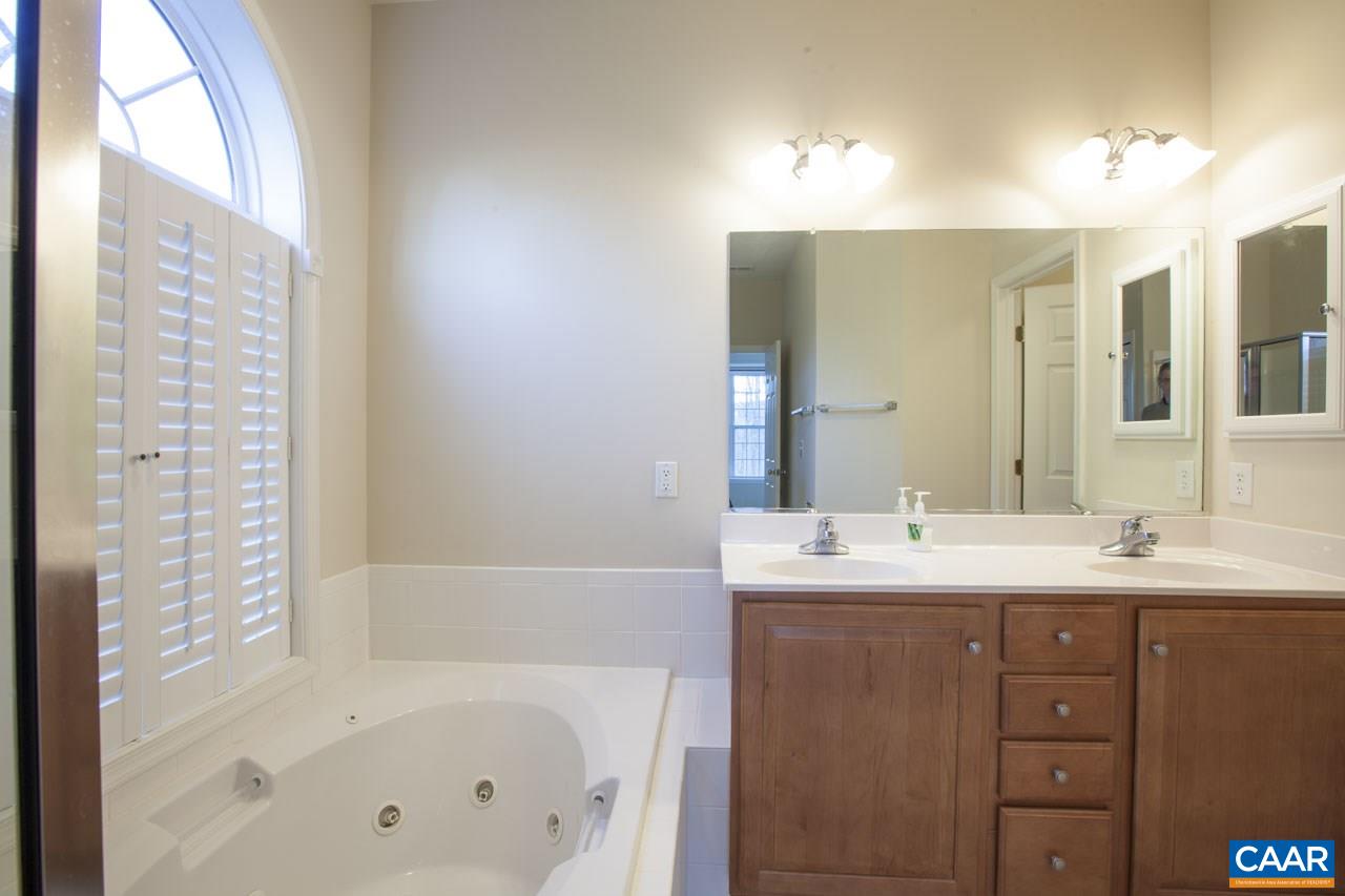 1981 Ridgetop Drive Charlottesville, VA 22903 - Photo 26 of 40 a bathroom with a tub sink and mirror