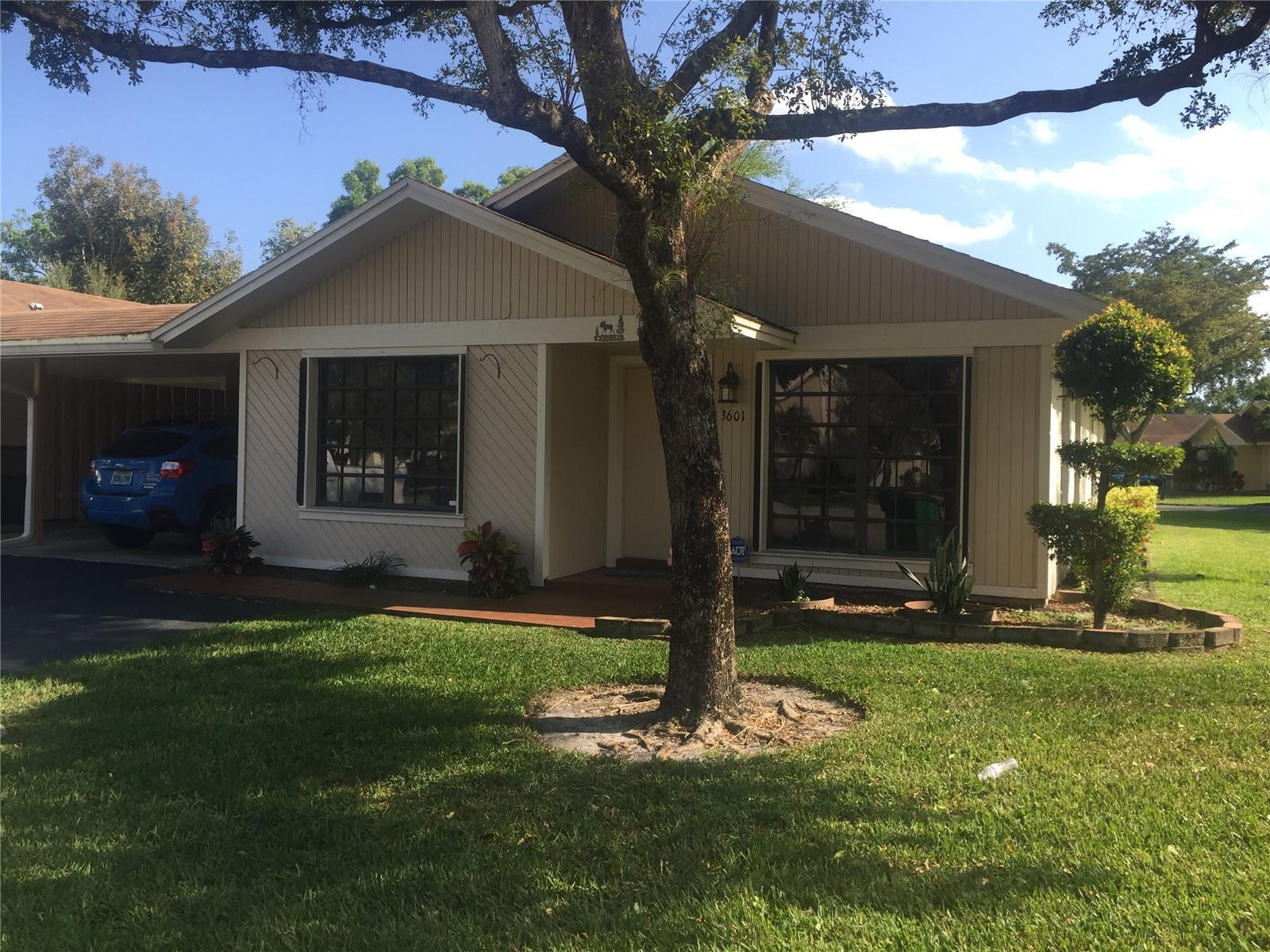 3601 East Forge Road, Unit 23 Davie, FL 33328 - Photo 1 of 17 a front view of a house with a yard