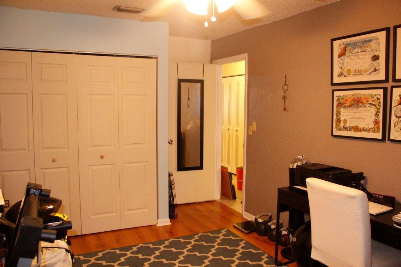 3601 East Forge Road, Unit 23 Davie, FL 33328 - Photo 17 of 17 a bedroom with a bed and wooden floor