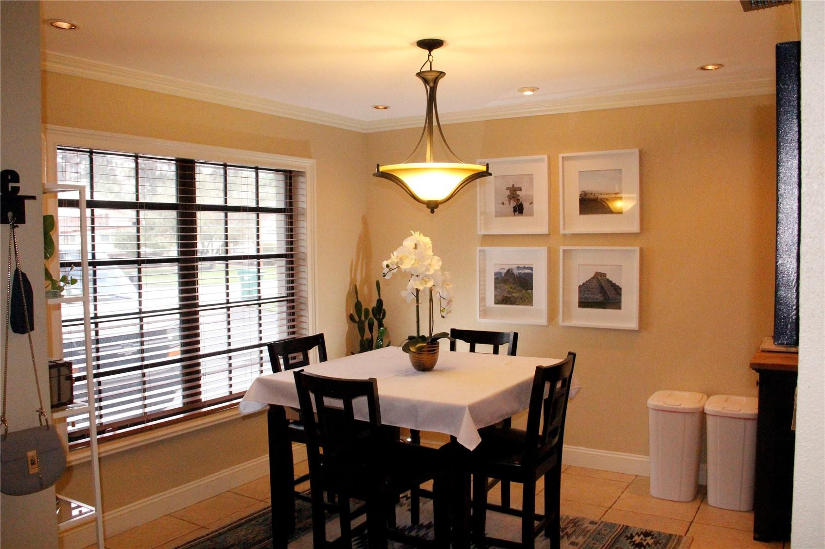 3601 East Forge Road, Unit 23 Davie, FL 33328 - Photo 4 of 17 a dining room with furniture a chandelier and window