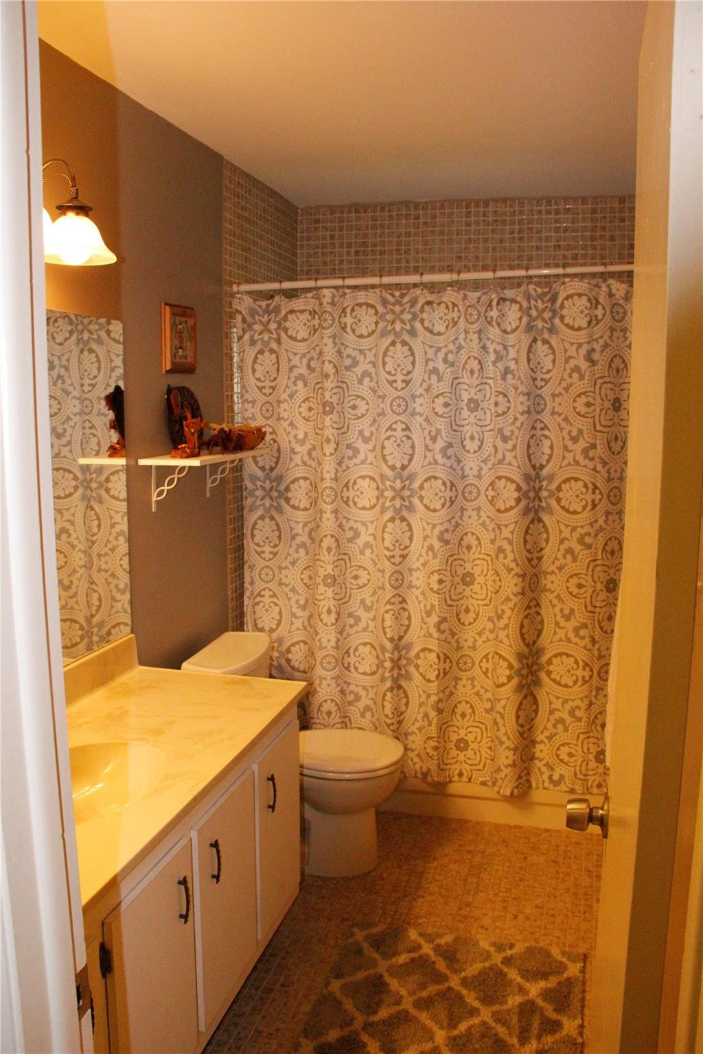 3601 East Forge Road, Unit 23 Davie, FL 33328 - Photo 8 of 17 a bathroom with a sink a toilet and shower curtain