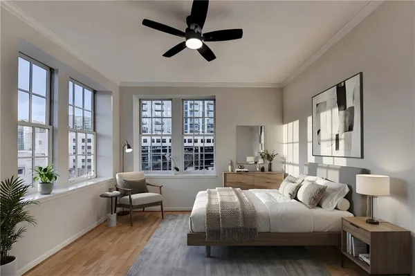 a spacious bedroom with a bed a couch and a large window