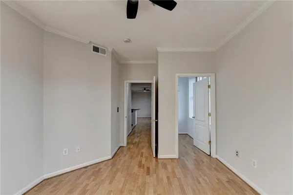 a view of a hallway with wooden floor
