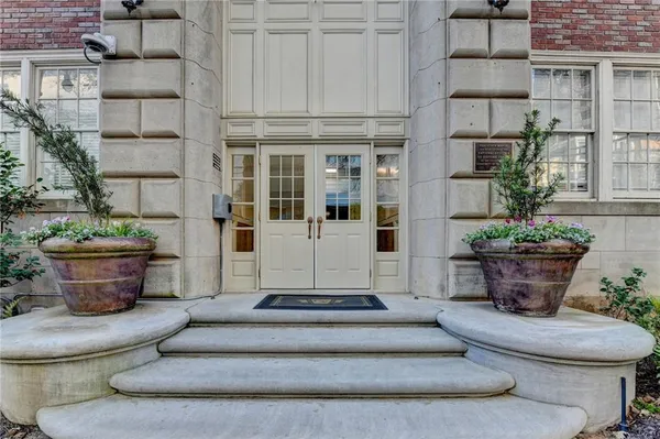 a view of a house with potted plants