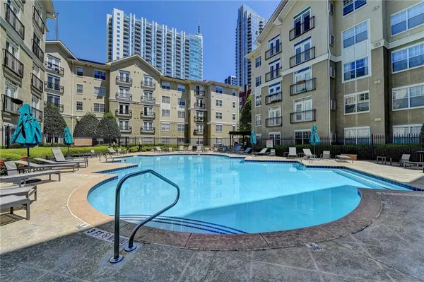 a swimming pool with outdoor seating and yard