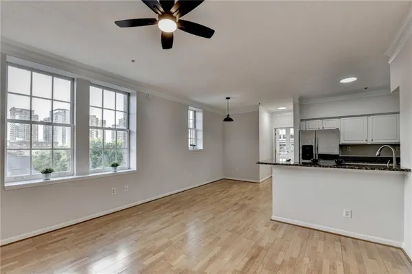 a kitchen with stainless steel appliances granite countertop a stove a sink and a large window