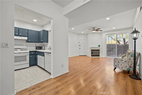 a kitchen with stainless steel appliances kitchen island granite countertop a stove top oven a sink and a refrigerator