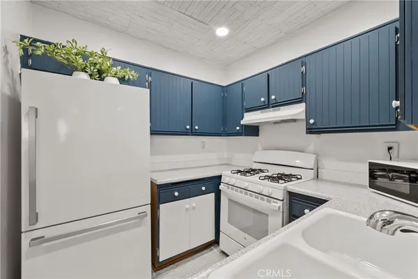 a kitchen with stainless steel appliances a refrigerator sink and cabinets