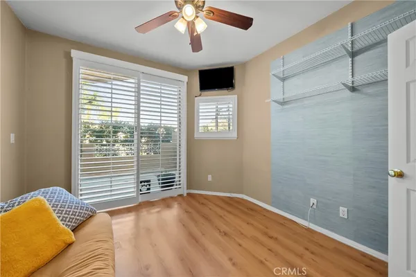 a view of a bedroom with a bed and a window