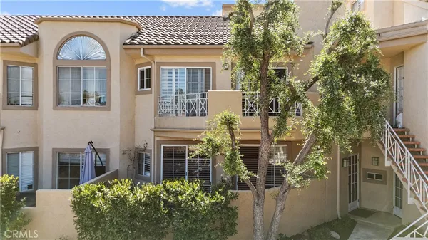 a view of a brick house with many windows