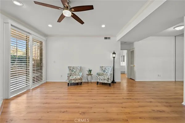 a view of empty room with furniture and window