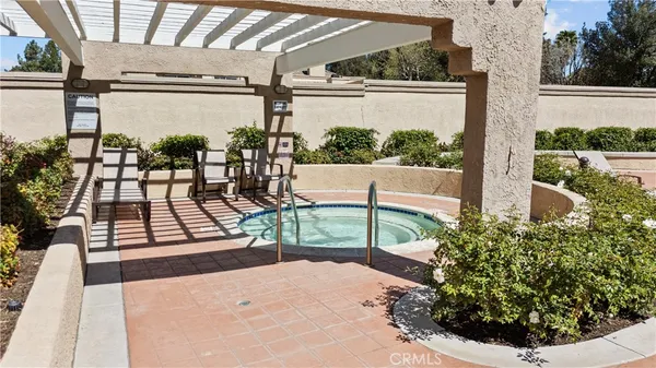 a view of a swimming pool with a patio and a garden