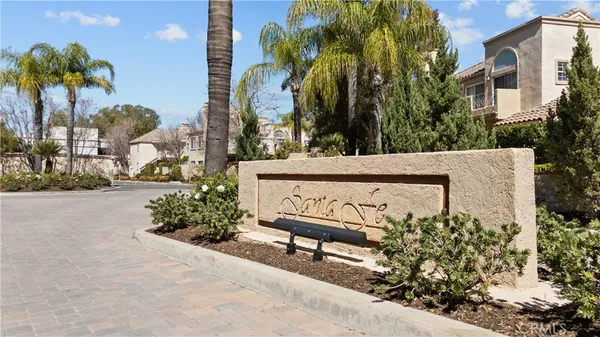 an aerial view of a house with a yard and large trees