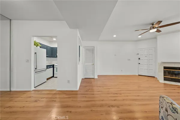 a view of a kitchen with a sink and a refrigerator